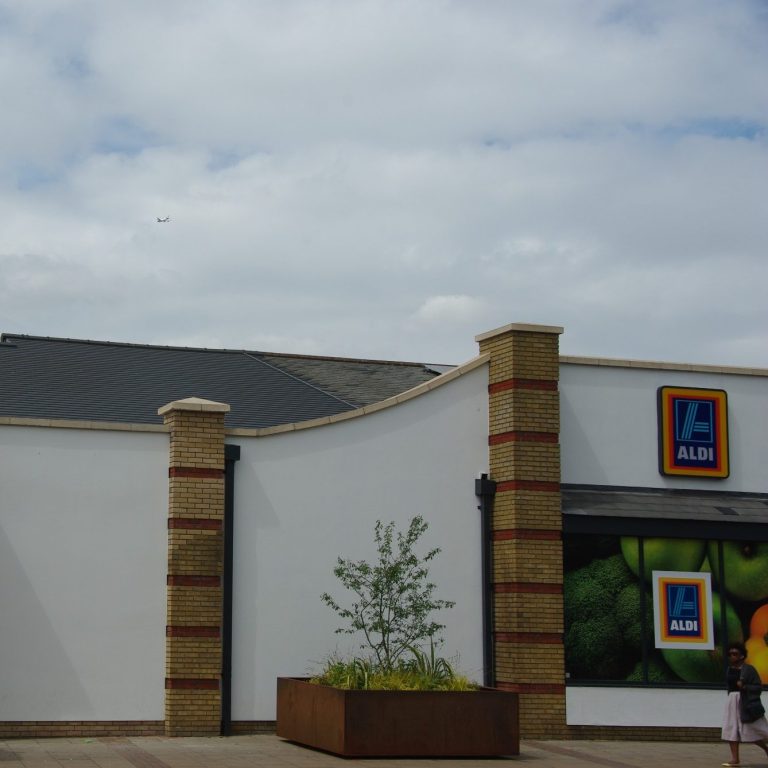 Newly constructed Aldi supermarket with sleek, Envirotile roof tiles, highlighting the modern eco-friendly design of the commercial building Newly constructed Aldi supermarket with sleek, Envirotile roof tiles, highlighting the modern eco-friendly design of the commercial building