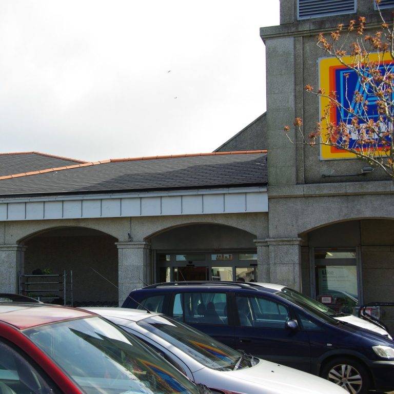 Aldi supermarket building featuring a roof fitted with Envirotile recycled plastic roof tiles, demonstrating commercial use Aldi supermarket building featuring a roof fitted with Envirotile recycled plastic roof tiles, demonstrating commercial use